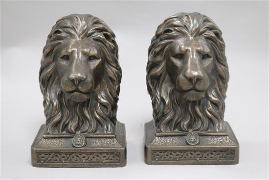 A bronzed resin horse and two lion bookends height 19cm